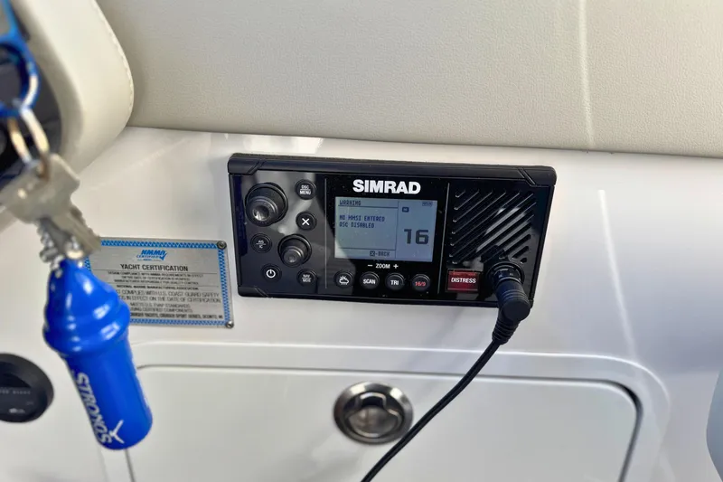 Slide: The Image of Simrad marine radio on 2024 Cruisers Yachts 38 GLS OB dashboard. - 40