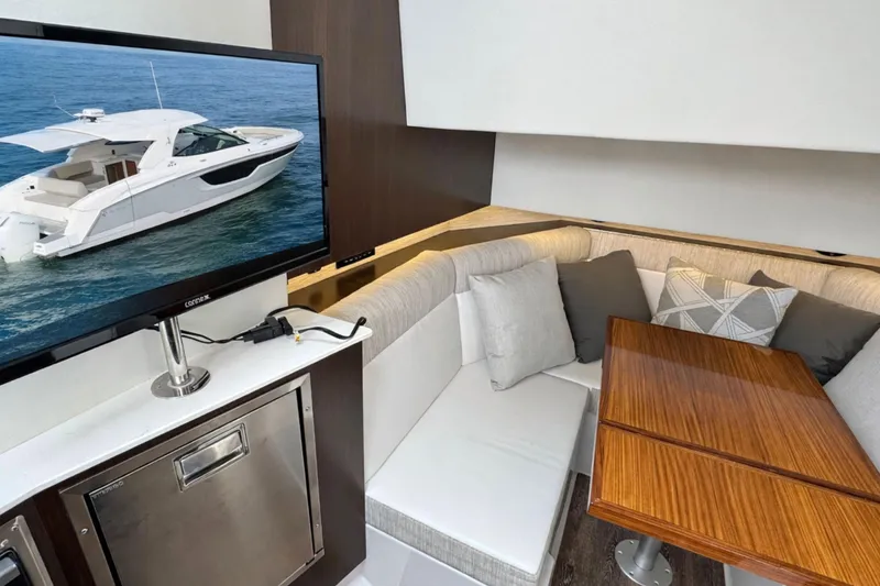 Slide: The Image of Luxurious interior of 2024 Cruisers Yachts 38 GLS OB with cozy seating and TV display. - 43