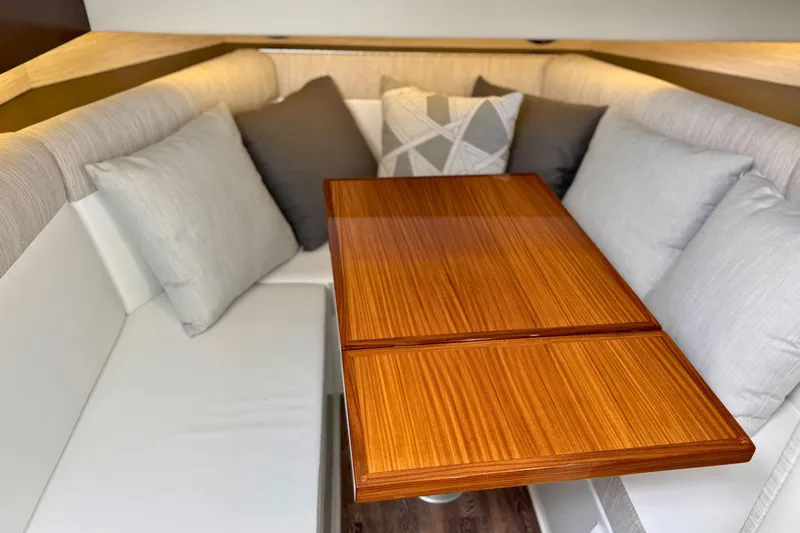 Slide: The Image of 2024 Cruisers Yachts 38 GLS OB interior with elegant seating and wooden table. - 45