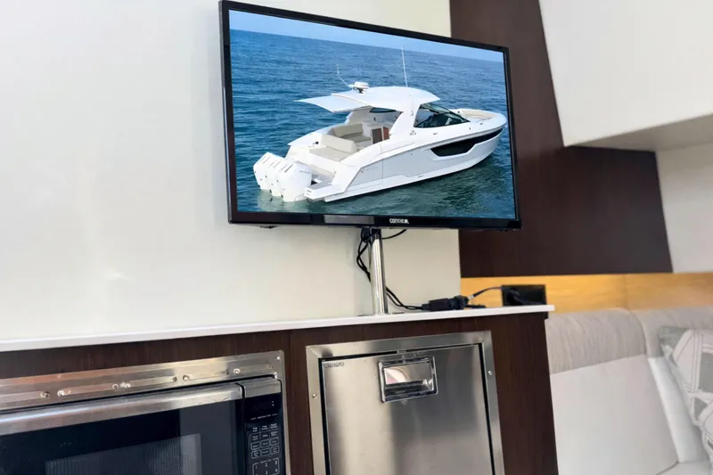 Slide: The Image of 2024 Cruisers Yachts 38 GLS OB displayed on a screen in a modern interior. - 46