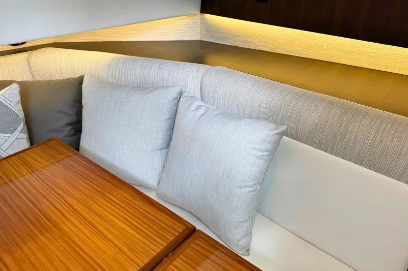 Slide: The Image of Luxurious interior seating with cushions on the 2024 Cruisers Yachts 38 GLS OB. - 49