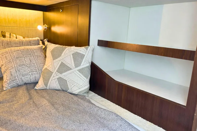 Slide: The Image of 2024 Cruisers Yachts 38 GLS OB cabin with cozy bedding and modern shelving. - 55