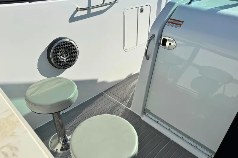 Slide: The Image of 2024 Cruisers Yachts 38 GLS OB interior with seating and speaker detail. - 57