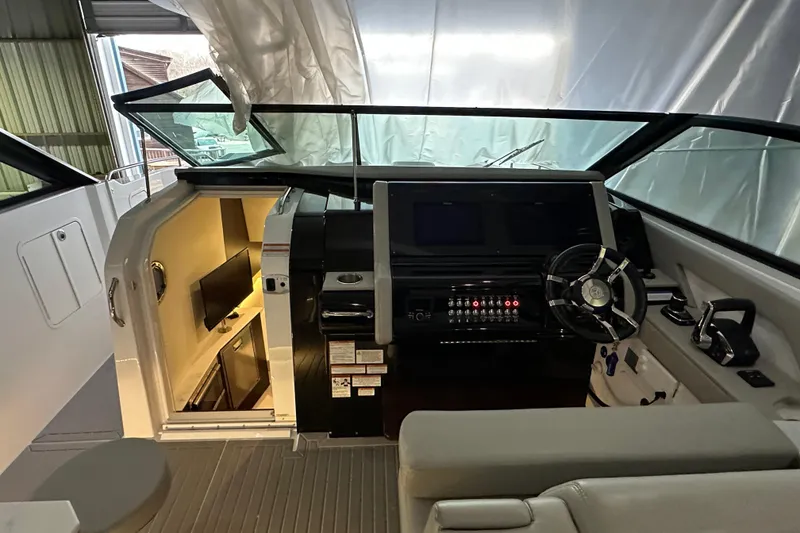 Slide: The Image of 2024 Cruisers Yachts 38 GLS OB helm with modern controls and cabin view. - 7