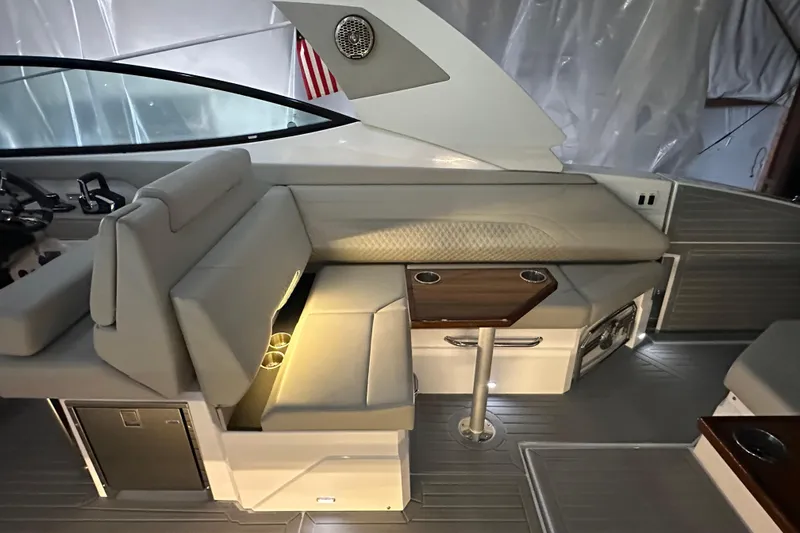 Slide: The Image of 2024 Cruisers Yachts 38 GLS OB interior with elegant seating and wooden table. - 8