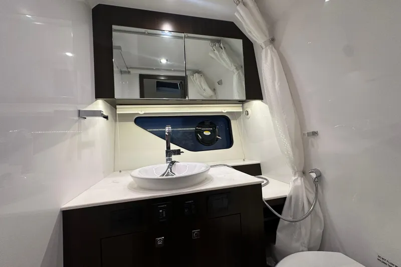 Slide: The Image of 2024 Cruisers Yachts 38 GLS OB bathroom with modern sink and mirror. - 14
