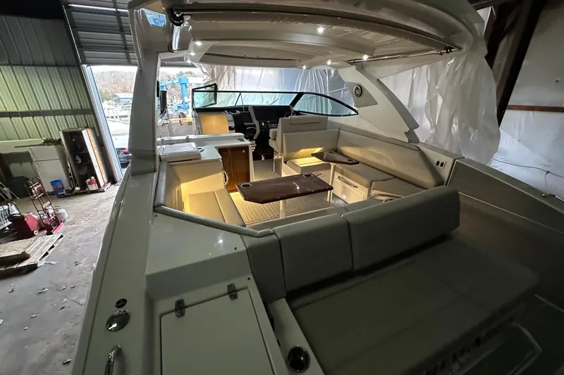 Slide: The Image of 2024 Cruisers Yachts 38 GLS OB interior with elegant seating and ambient lighting. - 2