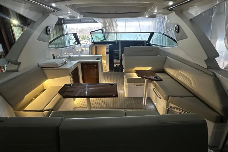 Slide: The Image of Luxurious interior of 2024 Cruisers Yachts 38 GLS OB with elegant seating and ambient lighting. - 3