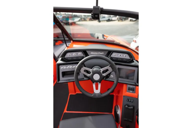 Slide: The Image of 2026 MasterCraft NXT24 boat dashboard with steering wheel and control panel. - 19