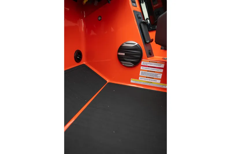 Slide: The Image of Interior of 2026 MasterCraft NXT24 boat with orange paneling and speaker. - 25