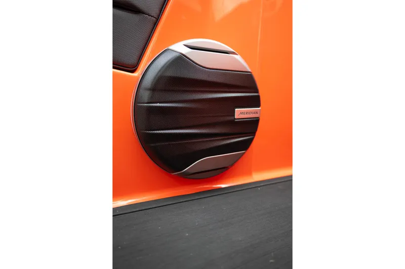 Slide: The Image of 2026 MasterCraft NXT24 boat with Meridian speaker on vibrant orange exterior. - 26