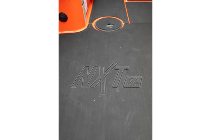 Slide: The Image of 2026 MasterCraft NXT24 boat floor with logo and orange accents. - 28