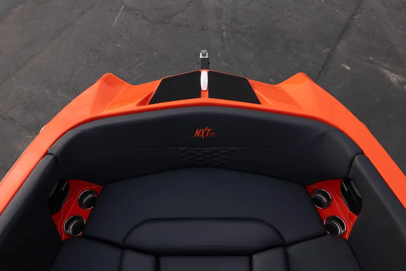 Slide: The Image of 2026 MasterCraft NXT24 boat interior with orange and black seating. - 29