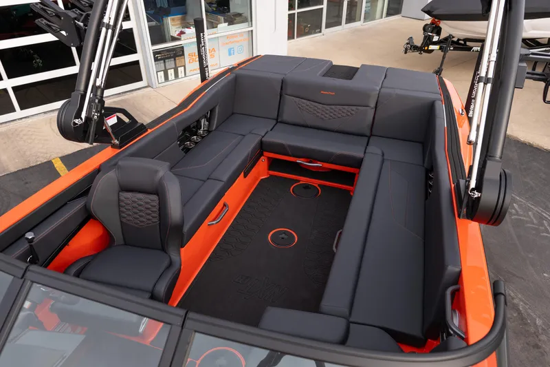 Slide: The Image of 2026 MasterCraft NXT24 boat interior with sleek black and orange seating design. - 32