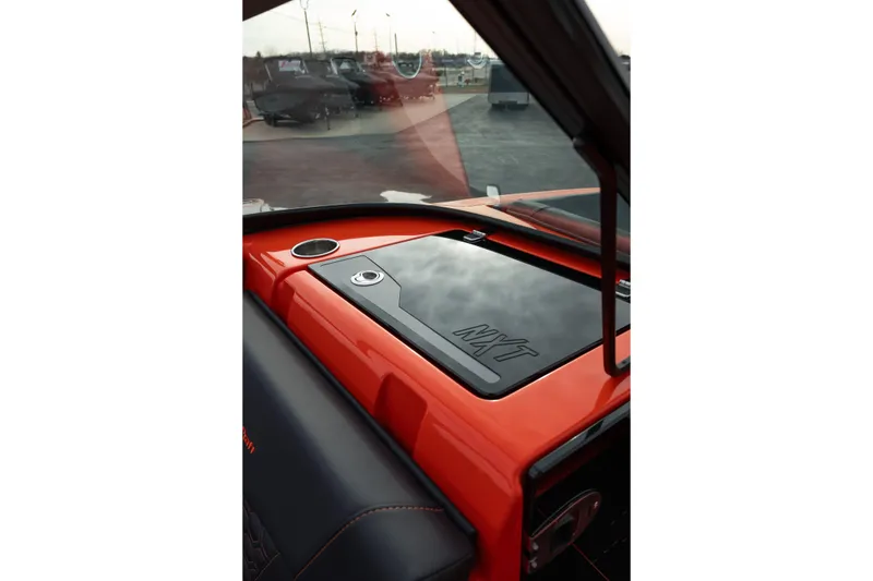 Slide: The Image of 2026 MasterCraft NXT24 boat dashboard with sleek design and vibrant orange accents. - 33
