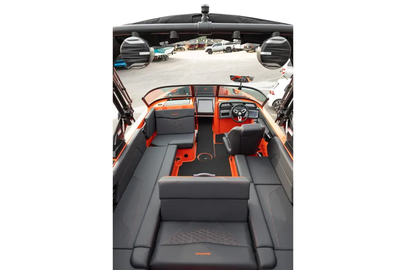 Slide: The Image of 2026 MasterCraft NXT24 boat interior with sleek black and orange seating and modern dashboard. - 35