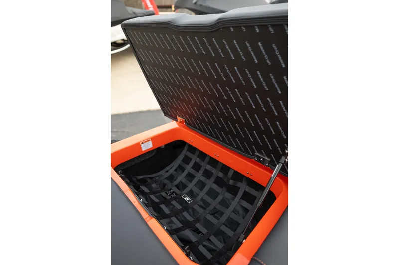 Slide: The Image of 2026 MasterCraft NXT24 boat storage compartment with open lid, showcasing interior design. - 37