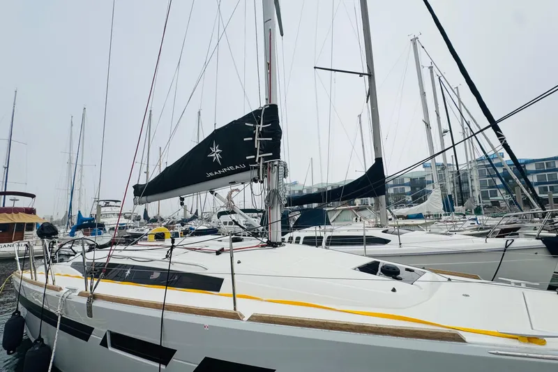 Slide: The Image of 2024 Jeanneau Sun Odyssey 349 sailboat docked at marina, mast and rigging visible. - 11