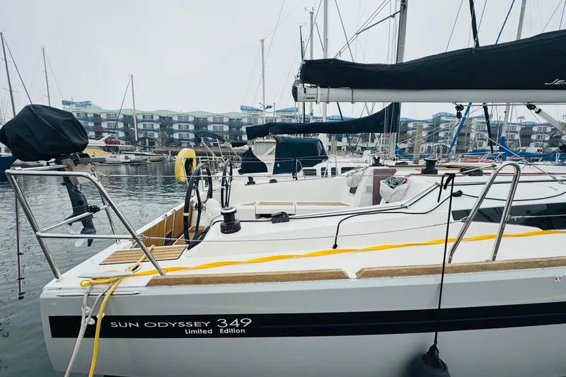 Slide: The Image of 2024 Jeanneau Sun Odyssey 349 sailboat docked in marina, showcasing sleek design and modern features. - 12