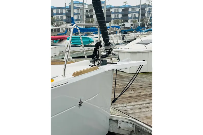 Slide: The Image of 2024 Jeanneau Sun Odyssey 349 sailboat docked, featuring anchor and deck details. - 18