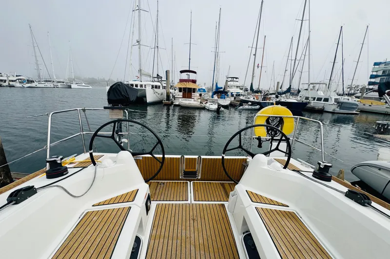 Slide: The Image of 2024 Jeanneau Sun Odyssey 349 sailboat with teak deck in marina. - 21