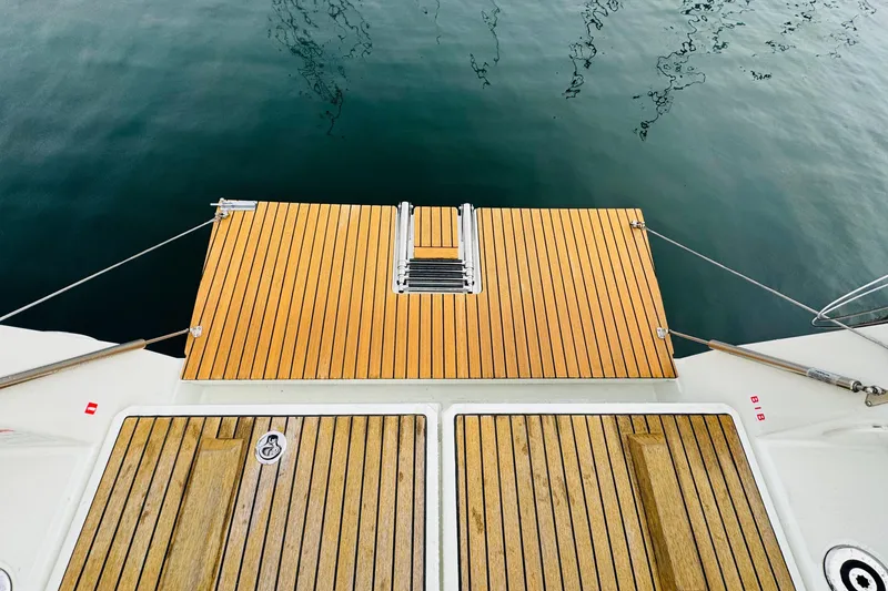 Slide: The Image of 2024 Jeanneau Sun Odyssey 349 sailboat with teak deck, docked in a marina. - 26