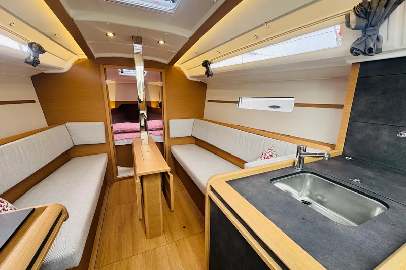 Slide: The Image of Interior of 2024 Jeanneau Sun Odyssey 349 sailboat, featuring cozy seating and wooden finishes. - 30