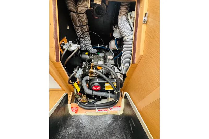 Slide: The Image of Engine compartment of 2024 Jeanneau Sun Odyssey 349 sailboat, showcasing mechanical components. - 67