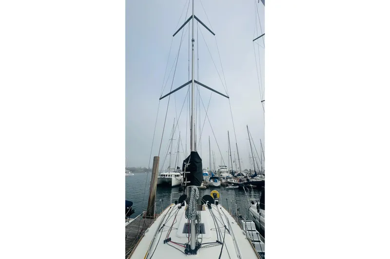 Slide: The Image of 2024 Jeanneau Sun Odyssey 349 sailboat at sunset with couple relaxing on deck. - 9