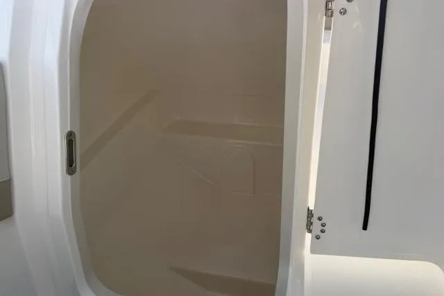 Slide: The Image of Interior view of 2026 Boston Whaler 210 Vantage boat compartment. - 18
