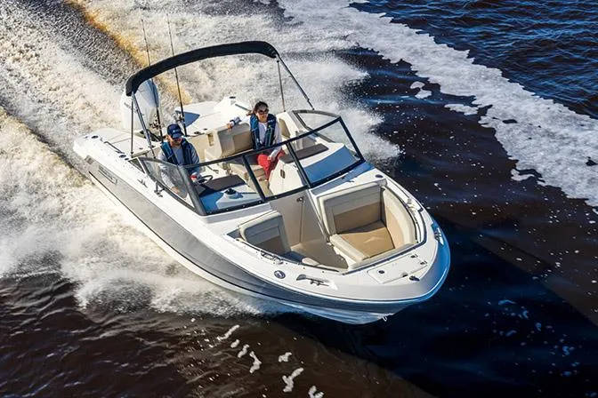 Slide: The Image of 2026 Boston Whaler 210 Vantage boat with outboard motor on display. - 2