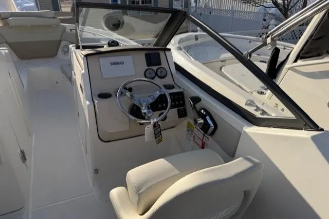 Slide: The Image of 2026 Boston Whaler 210 Vantage boat cockpit with steering wheel and control panel. - 20