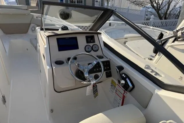 Slide: The Image of 2026 Boston Whaler 210 Vantage boat cockpit with steering wheel and control panel. - 21