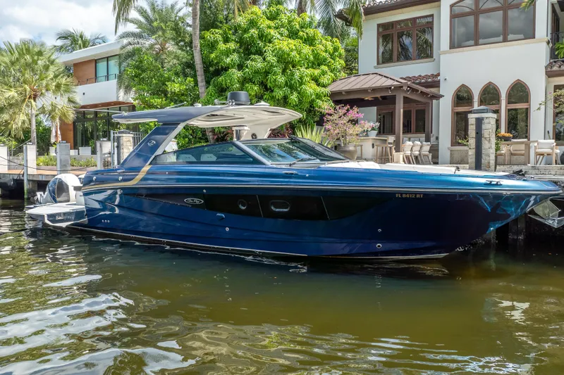 Slide: The Image of 2019 Sea Ray SLX 400 Outboard boat docked by a luxurious waterfront home. - 10