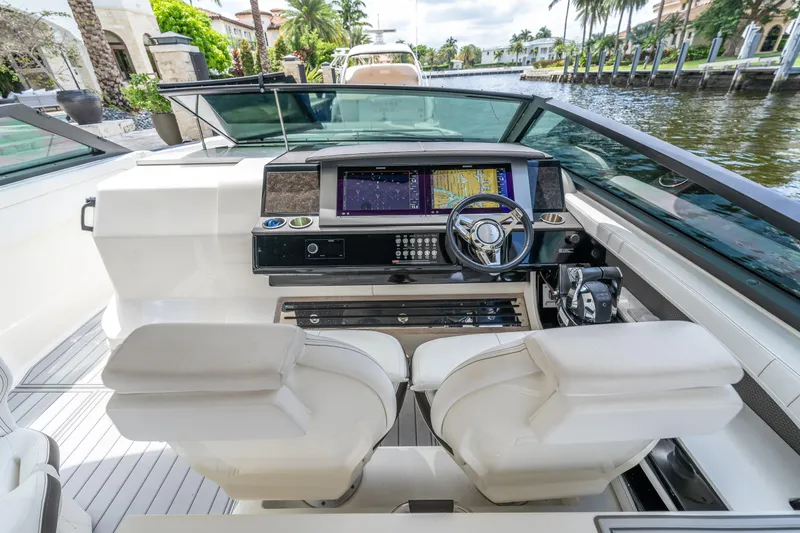 Slide: The Image of 2019 Sea Ray SLX 400 Outboard helm with modern navigation system and luxurious seating. - 12