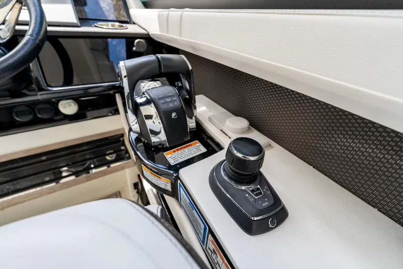 Slide: The Image of 2019 Sea Ray SLX 400 Outboard helm controls with joystick and throttle. - 14