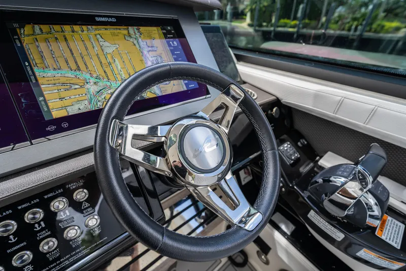 Slide: The Image of 2019 Sea Ray SLX 400 Outboard helm with navigation display and controls. - 16