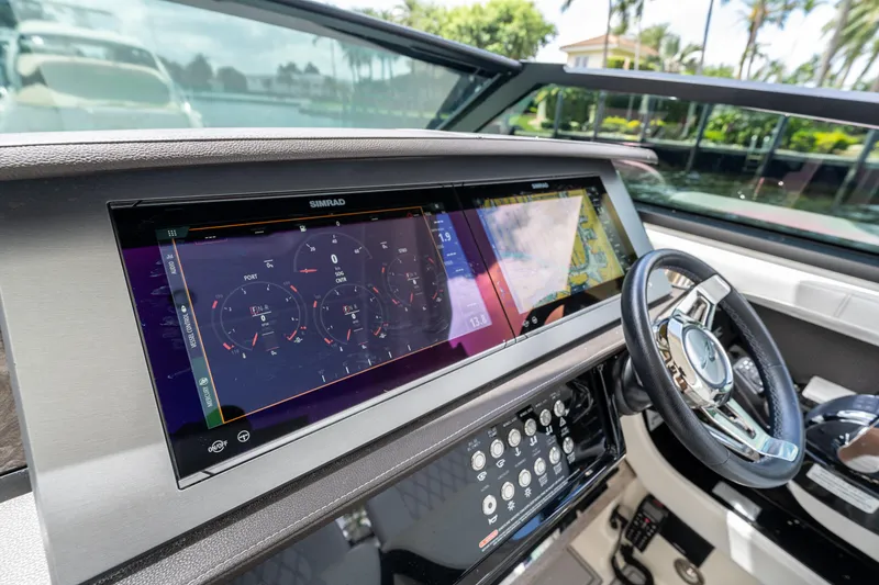 Slide: The Image of 2019 Sea Ray SLX 400 Outboard dashboard with advanced navigation display and controls. - 18