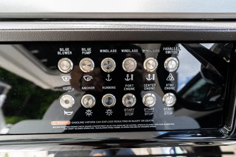 Slide: The Image of Control panel of a 2019 Sea Ray SLX 400 Outboard boat with various switches. - 19