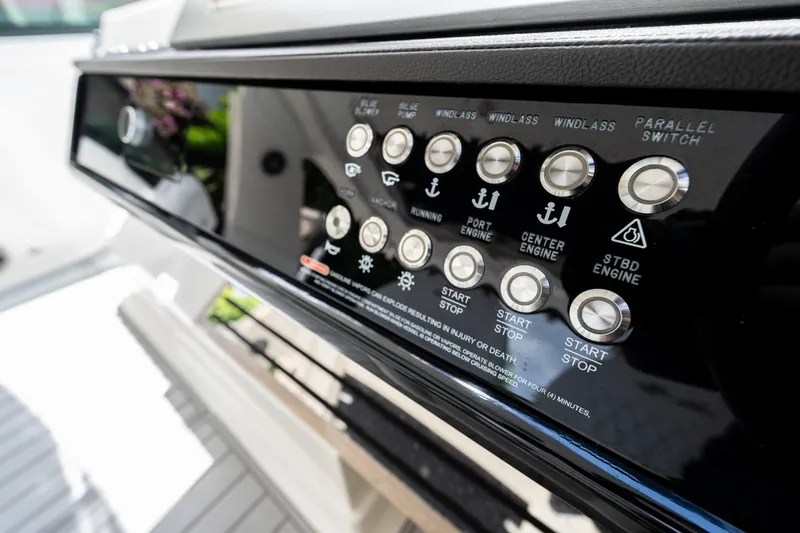 Slide: The Image of Control panel of 2019 Sea Ray SLX 400 Outboard boat with various engine and system buttons. - 20