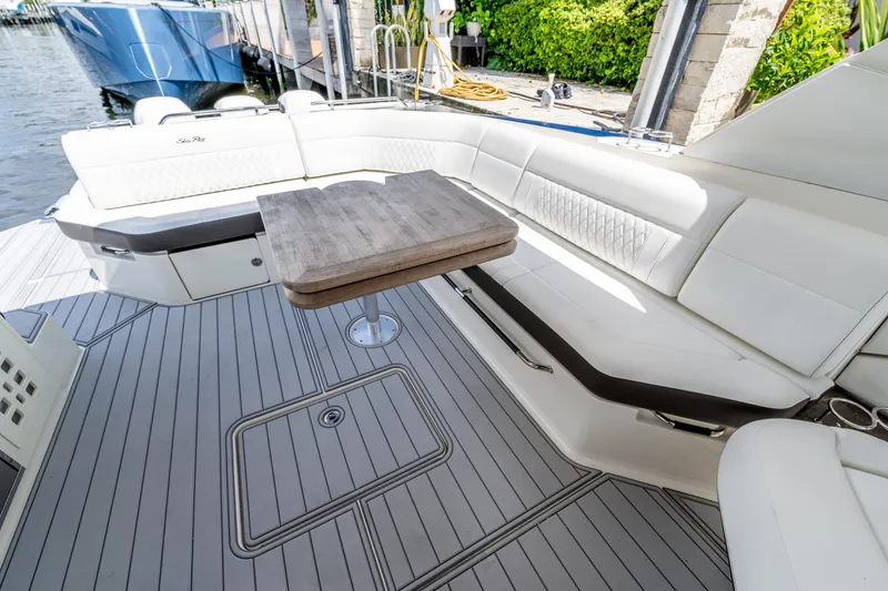 Slide: The Image of Luxurious seating area on 2019 Sea Ray SLX 400 Outboard with elegant table and sleek design. - 25