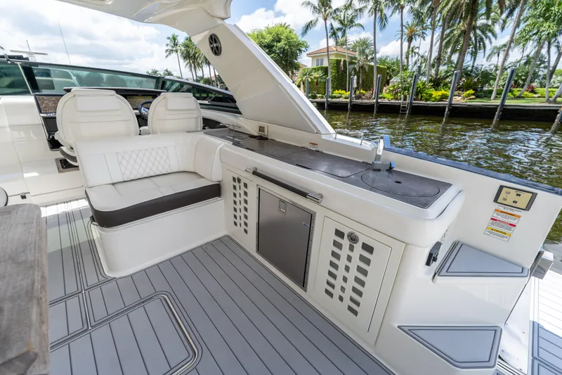 Slide: The Image of Luxurious 2019 Sea Ray SLX 400 Outboard boat interior with seating and kitchenette. - 26