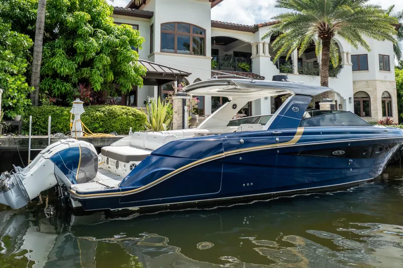 Slide: The Image of 2019 Sea Ray SLX 400 Outboard boat docked by a luxurious waterfront home. - 3