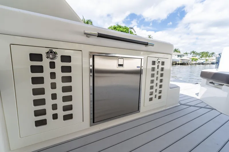 Slide: The Image of 2019 Sea Ray SLX 400 Outboard deck with stainless steel storage and scenic waterfront view. - 31