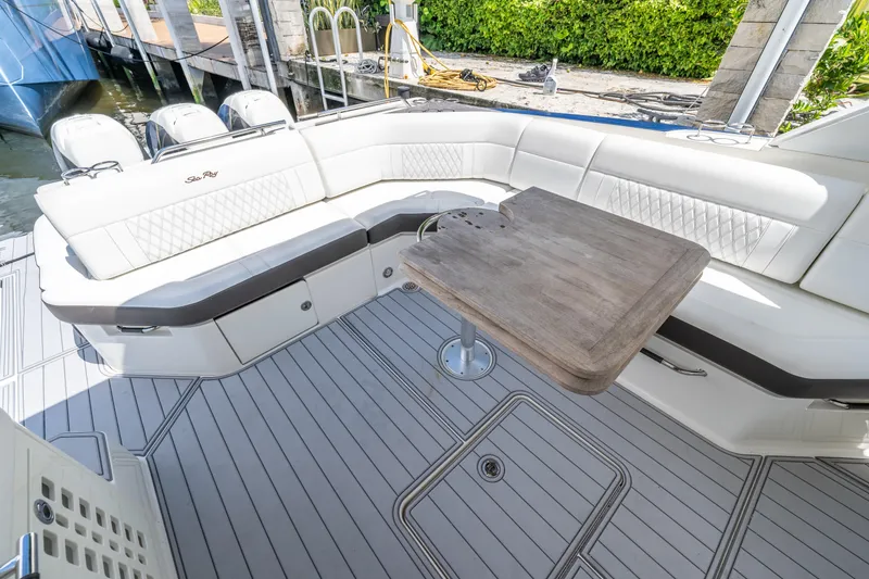 Slide: The Image of 2019 Sea Ray SLX 400 Outboard boat interior with seating and wooden table. - 32