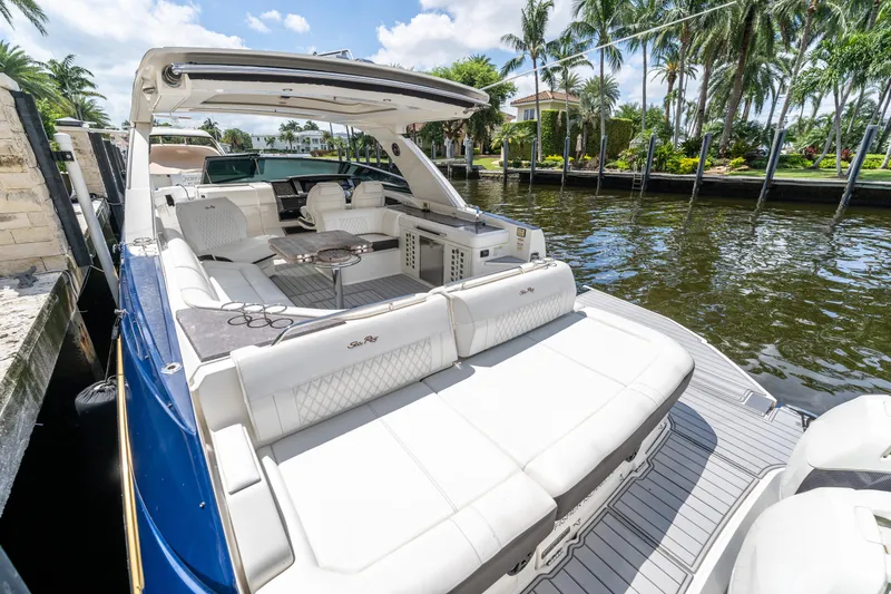 Slide: The Image of 2019 Sea Ray SLX 400 Outboard luxury boat docked by palm trees. - 37