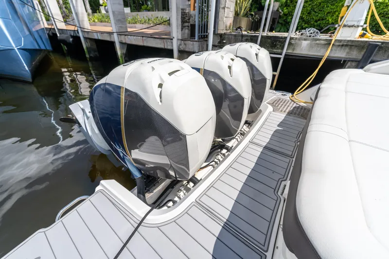 Slide: The Image of 2019 Sea Ray SLX 400 Outboard with triple engines docked at marina. - 38