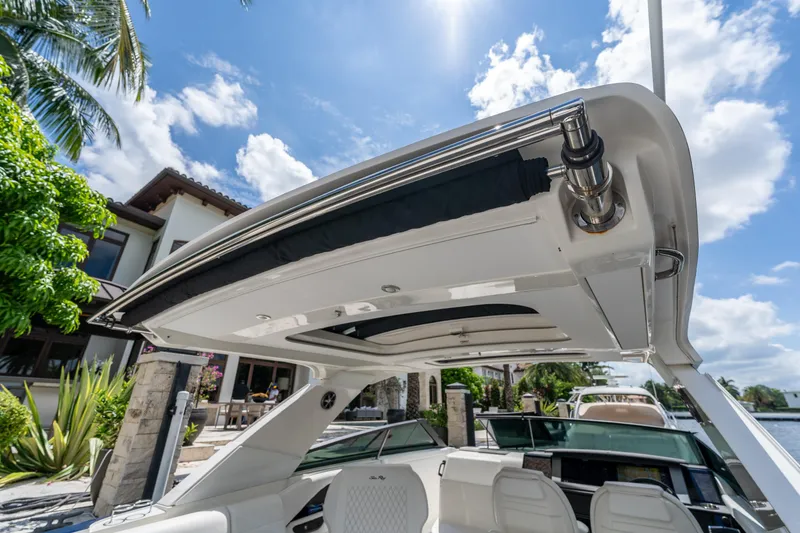 Slide: The Image of 2019 Sea Ray SLX 400 Outboard boat with sleek design under a sunny sky. - 39