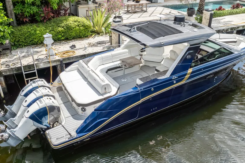 Slide: The Image of 2019 Sea Ray SLX 400 Outboard luxury boat docked, featuring sleek design and spacious seating. - 4