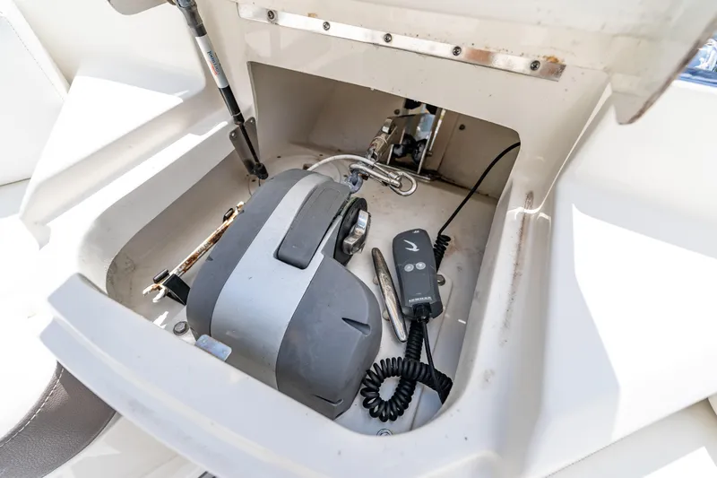 Slide: The Image of 2019 Sea Ray SLX 400 Outboard storage compartment with equipment and controls. - 44